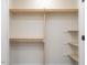 Walk-in closet with custom-built wooden shelving and ample storage space at 4664 Quarter Creek Ln, Liberty, NC 27298
