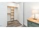 A closet with custom shelving and a wooden-look floor at 4664 Quarter Creek Ln, Liberty, NC 27298