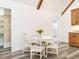 Charming dining area with a white table, wood beams, and modern flooring at 4664 Quarter Creek Ln, Liberty, NC 27298