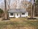 Charming single-story home featuring a cozy front porch with rocking chairs and well-maintained landscaping at 4664 Quarter Creek Ln, Liberty, NC 27298