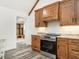 Bright kitchen featuring stainless steel oven, wood cabinetry, and stylish countertops at 4664 Quarter Creek Ln, Liberty, NC 27298