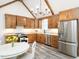 Modern kitchen with stainless steel appliances, wooden cabinets and granite counters at 4664 Quarter Creek Ln, Liberty, NC 27298