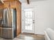 Modern kitchen adjacent to a door leading to the exterior, with sleek stainless steel appliances at 4664 Quarter Creek Ln, Liberty, NC 27298