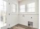 Bright laundry room with white shiplap walls, utility connections, and access to the deck at 4664 Quarter Creek Ln, Liberty, NC 27298