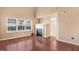 Bright living room with hardwood floors, a fireplace, and large windows, perfect for relaxing and entertaining at 5416 Kissimmee Ln, Raleigh, NC 27616