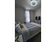 Bright bedroom with a large window and bed with blue striped bedding at 5943 River Landings Dr, Raleigh, NC 27616