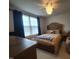 Cozy bedroom featuring a comfortable bed, ceiling fan, and dark curtains at 5943 River Landings Dr, Raleigh, NC 27616