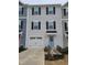 Charming townhome with a white garage door and a light blue front door, perfect for curb appeal at 5943 River Landings Dr, Raleigh, NC 27616