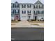 View of newly built townhomes with attached garages and colorful doors at 5943 River Landings Dr, Raleigh, NC 27616