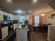 An eat-in kitchen features white cabinetry and an island adjacent to the dining area at 5943 River Landings Dr, Raleigh, NC 27616