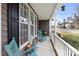 Cozy porch featuring rocking chairs, decorative lanterns, and view of the neighborhood at 6002 Rustic Wood Ln, Durham, NC 27713