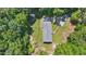 Aerial view of home nestled among lush green trees, highlighting its privacy and serene natural setting at 610 Apple St, Gibsonville, NC 27249