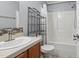 This bathroom features a sink, toilet and shower with a storage shelf at 610 Apple St, Gibsonville, NC 27249