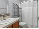 This bathroom features a sink, toilet and shower curtain with storage shelving at 610 Apple St, Gibsonville, NC 27249