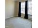 Bedroom with dual windows and dark colored curtains for light control at 610 Apple St, Gibsonville, NC 27249