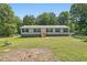 Charming single-story home with light siding, complemented by teal shutters and a well-maintained lawn at 610 Apple St, Gibsonville, NC 27249
