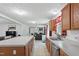 Open kitchen with island, stainless steel dishwasher, and view into the living room at 610 Apple St, Gibsonville, NC 27249