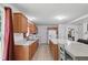 Efficient kitchen with light wood cabinets, white appliances, and a breakfast bar offering seating at 610 Apple St, Gibsonville, NC 27249