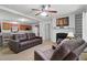 Comfortable living area featuring plush sofas, a fireplace, and seamless flow into the kitchen for easy entertaining at 610 Apple St, Gibsonville, NC 27249