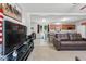 Inviting living space with neutral walls, plush sofa, and an open layout flowing into the kitchen at 610 Apple St, Gibsonville, NC 27249