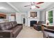 Comfortable living area featuring plush sofas, a fireplace, and seamless flow into the kitchen for easy entertaining at 610 Apple St, Gibsonville, NC 27249