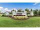 Inviting entrance to the neighborhood with manicured landscaping at 63 Lynn Crest Way, Four Oaks, NC 27524