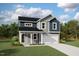 Charming two-story home boasts a classic color scheme, complemented by a well-manicured lawn and inviting front porch at 63 Lynn Crest Way, Four Oaks, NC 27524