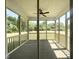 View of screened in porch with ceiling fan and views of the backyard at 63 Lynn Crest Way, Four Oaks, NC 27524
