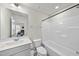 Clean bathroom featuring a large mirror, vanity, and a shower-tub combo at 6318 Perry Creek Rd, Raleigh, NC 27616