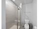 Clean bathroom featuring a tiled shower with a glass door and modern toilet at 6318 Perry Creek Rd, Raleigh, NC 27616