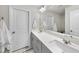 Bright bathroom with double sinks, quartz countertop, modern fixtures, and neutral decor at 6318 Perry Creek Rd, Raleigh, NC 27616