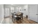 Cozy dining area with wood floors, a rustic table, and natural light from a nearby window at 6318 Perry Creek Rd, Raleigh, NC 27616