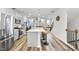 Bright, open kitchen with stainless appliances, island with bar seating, and hardwood floors at 6318 Perry Creek Rd, Raleigh, NC 27616