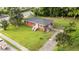 Aerial view showcasing the home's layout, manicured lawn, and proximity to a tree-lined neighborhood at 702 Joyner St, Clayton, NC 27520