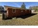Home's brick exterior and grassy backyard are ready for entertaining at 702 Joyner St, Clayton, NC 27520