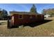 Backyard of a brick home with mature trees and landscaping at 702 Joyner St, Clayton, NC 27520
