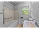 Small bathroom featuring a shower/tub combo, toilet, and an aged sink at 702 Joyner St, Clayton, NC 27520