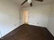 Empty bedroom with a ceiling fan and hardwood floors with access to another room at 702 Joyner St, Clayton, NC 27520