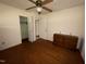 Bedroom featuring hardwood floors, and a ceiling fan, with access to other rooms at 702 Joyner St, Clayton, NC 27520