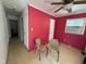 Cozy bedroom with bright red walls, tiled floors, and a window air conditioning unit at 702 Joyner St, Clayton, NC 27520