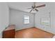 Bedroom with hardwood floors, two windows, and a chest of drawers at 702 Joyner St, Clayton, NC 27520
