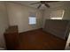 Bedroom featuring hardwood floors, two windows for natural light, and a ceiling fan at 702 Joyner St, Clayton, NC 27520