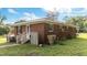 A charming brick home with a white door, fenced porch, and some greenery around the exterior of the house at 702 Joyner St, Clayton, NC 27520