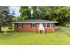 Charming brick home with a manicured front lawn, traditional curb appeal, and a welcoming front entrance at 702 Joyner St, Clayton, NC 27520
