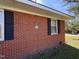 Close-up of brickwork with black shutters and white framed windows at 702 Joyner St, Clayton, NC 27520
