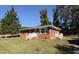 Charming brick home featuring a well-manicured lawn and bright white trim at 702 Joyner St, Clayton, NC 27520