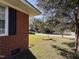 Landscaped yard with mature trees and a charming bird bath at 702 Joyner St, Clayton, NC 27520