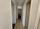 Hallway with tile flooring with doors on either side leading to other rooms in the home at 702 Joyner St, Clayton, NC 27520