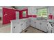 Bright kitchen features white cabinets, a double sink, and a window offering natural light at 702 Joyner St, Clayton, NC 27520