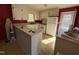 Functional kitchen with white cabinets, counter space, and essential appliances and a vinyl floor at 702 Joyner St, Clayton, NC 27520